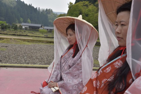 Mr. Ugyen Dorji's sister and his wife are wearing the Warring State Period's kimono and sitting on the stage outside