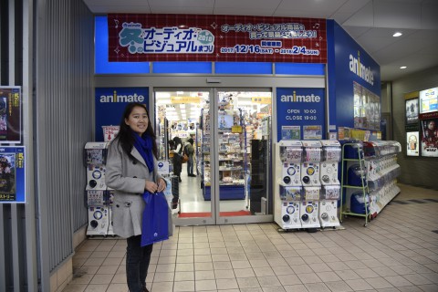 Sonam Choki standing in front of an animation store called “animate” which is a large chain of anime stores in Japan