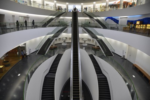 a long escalator near the entrance of museum