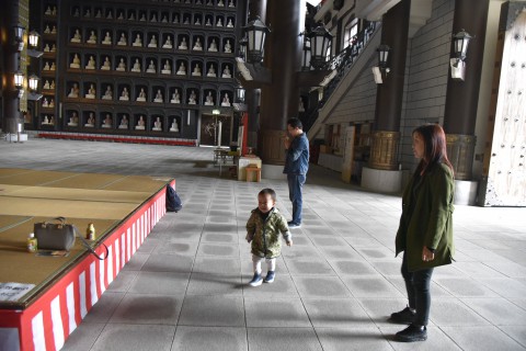 Mr. Ugen Dorji's son who is 2 years old running around in front of the Echizen Great Buddha of Seidai-ji temple